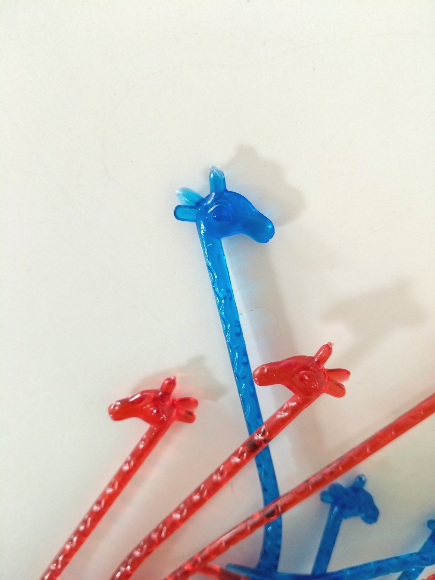 4 agitateurs à cocktail girafe en plastique bleus ou rouges au choix